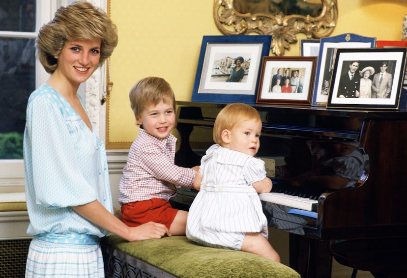 Princess Diana and the boys sit around the piano