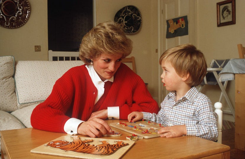 Princess Diana does a jigsaw puzzle with her son Prince William.
