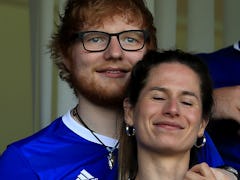 Ed Sheeran and Cherry Seaborn attend a sports game.