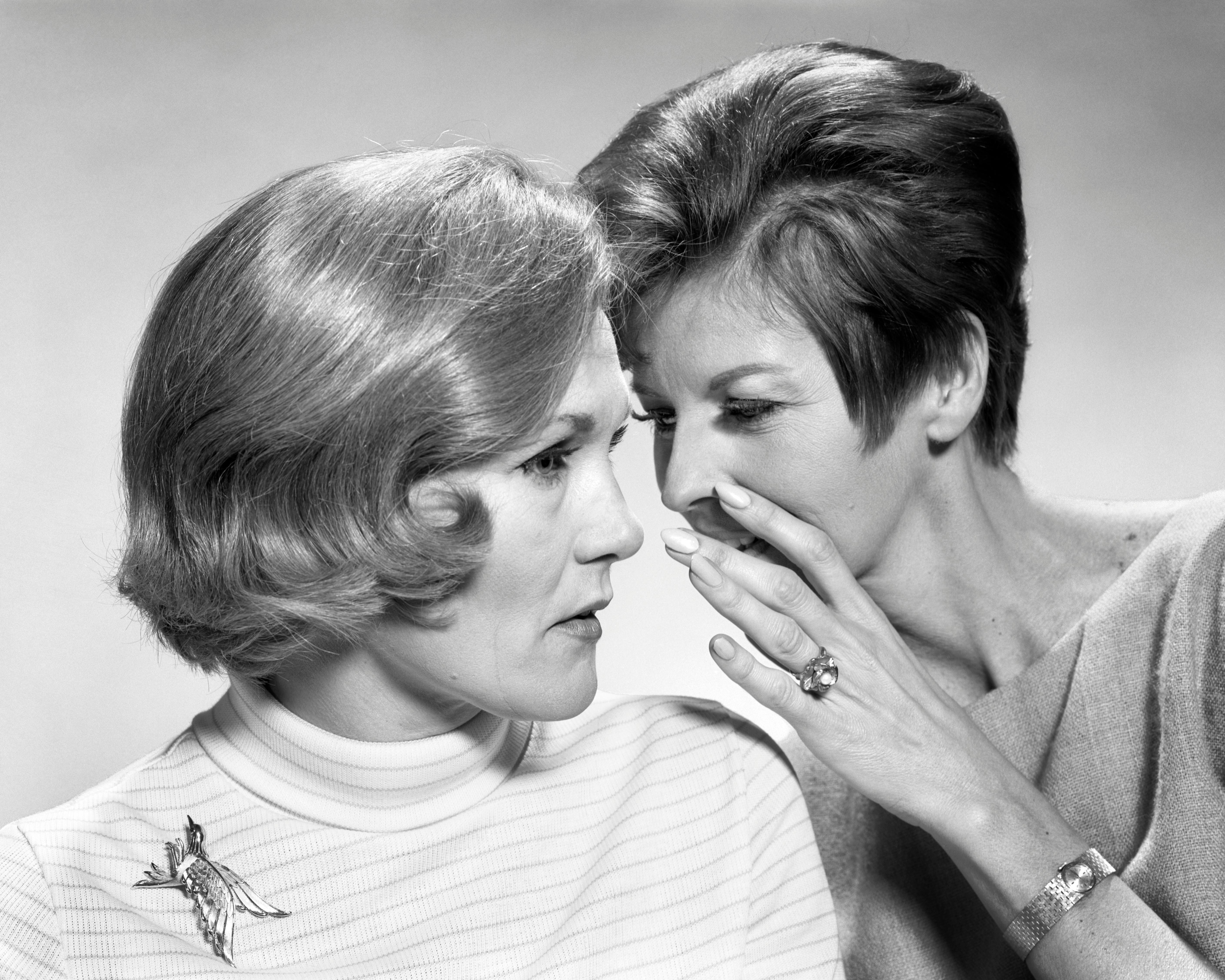A woman tells her friend a secret. Researchers told the Atlantic that talking quietly could lower co...