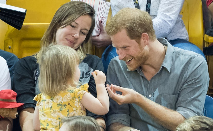 Prince Harry patiently allowed a little girl to steal his popcorn.