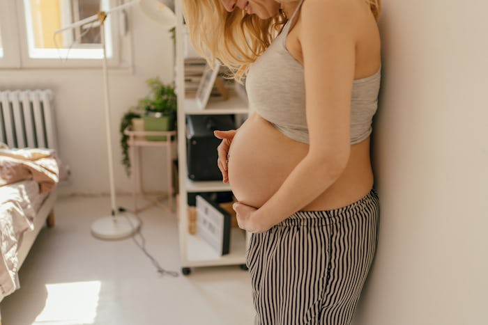 pregnant woman holding belly