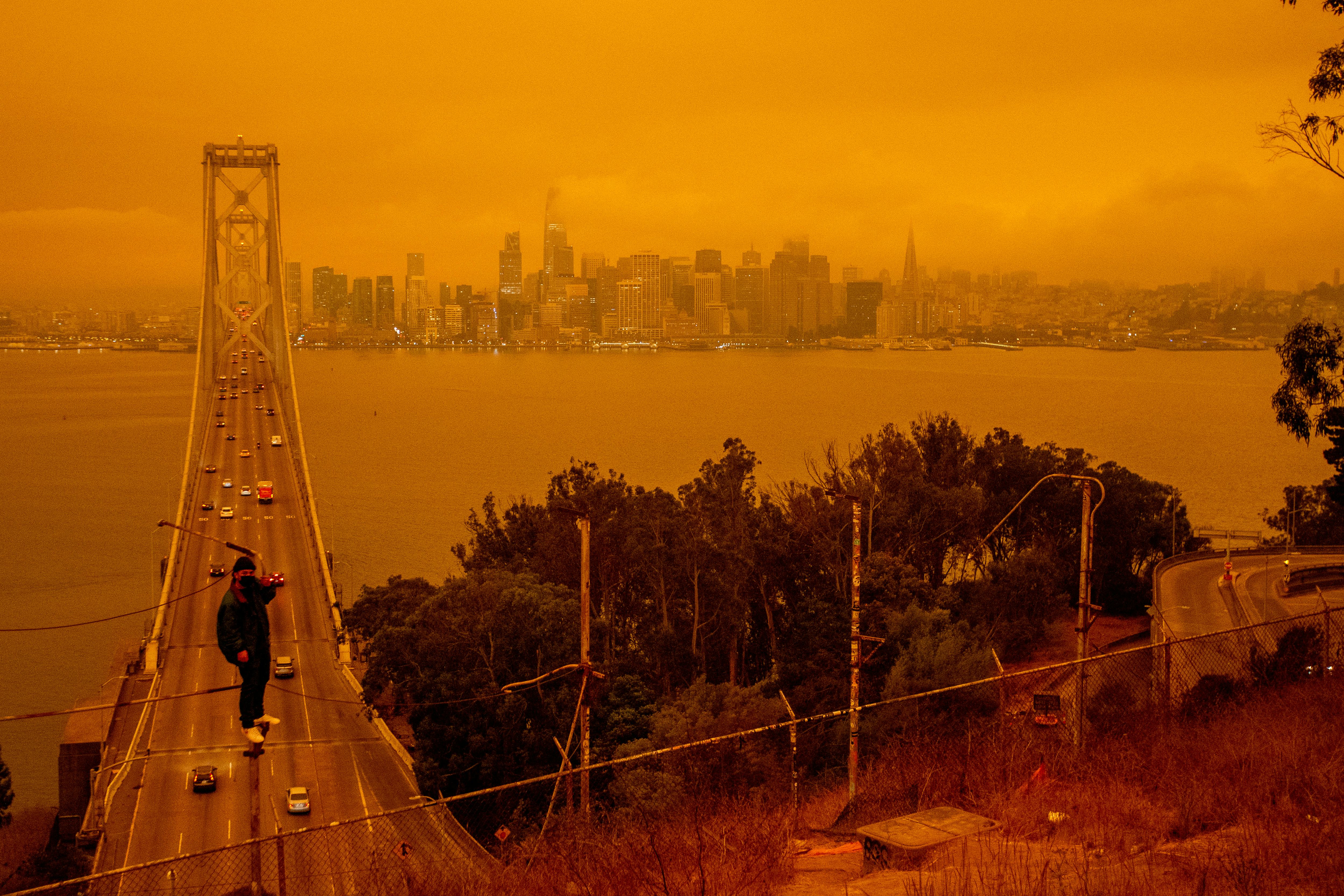 View from the air of a male person walking on the top of the bridge