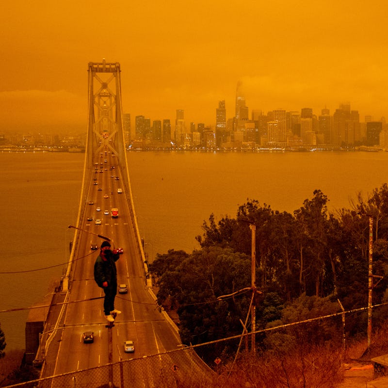 View from the air of a male person walking on the top of the bridge