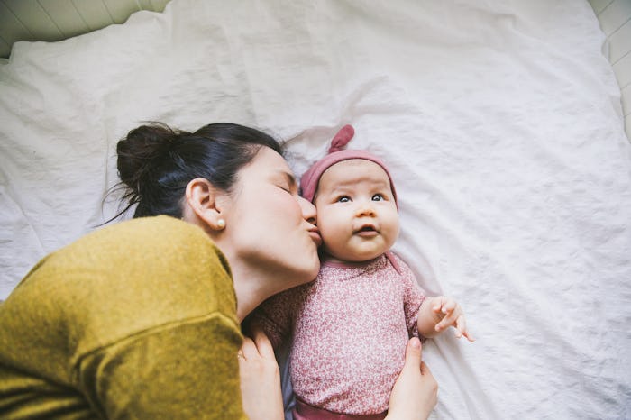 baby girl and mom snuggling