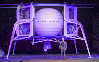 Amazon CEO Jeff Bezos stands beside the Blue Origin lunar lander. 