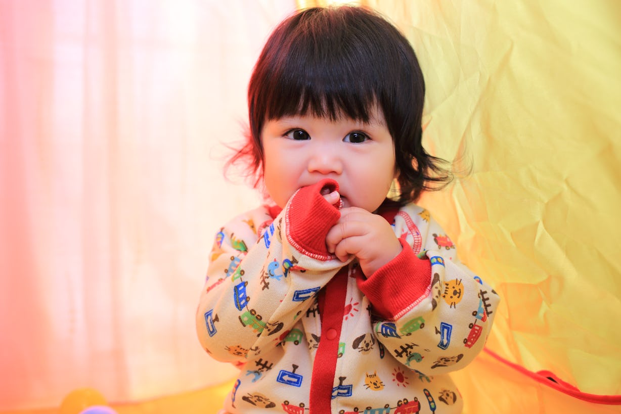 Why Do Babies Chew On Their Sleeves? Here's What Pediatricians Say