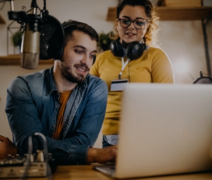 Two people recording a podcast.
