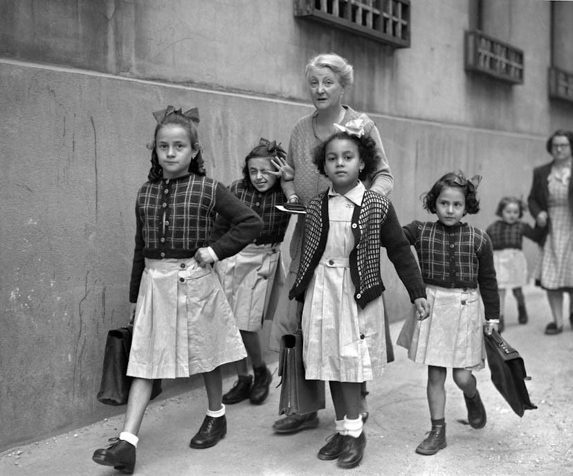 This vintage back to school photo shows a group of girls walking to school. 