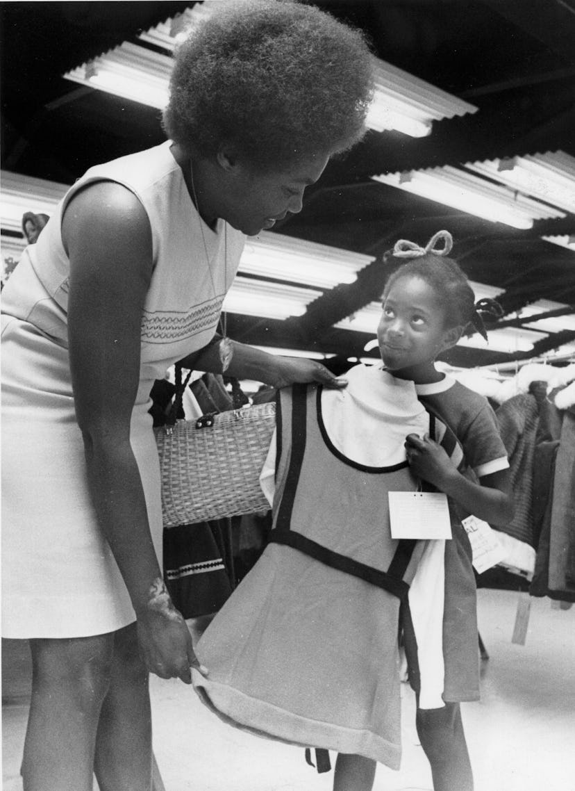 This vintage back to school photo shows a mom and daughter shopping for school clothes. 