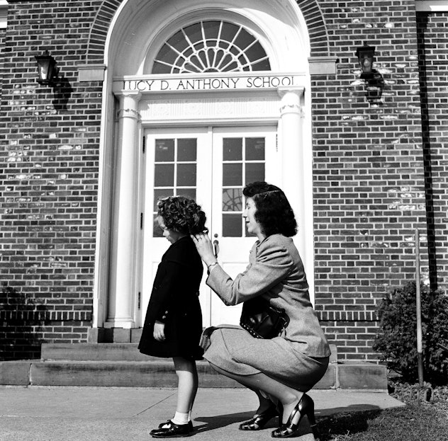 This vintage back to school photo shows a mom putting the finishing touches on her child's first day...