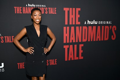Samira Wiley wearing a black dress while smiling event of The Handmaid’s Tale