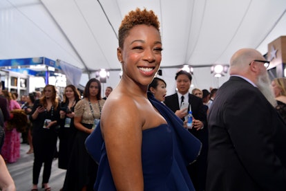 Samira Wiley smiling while wearing a blue dress on a public event