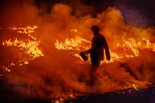 A firefighter battles the 2020 West Coast fires. Here's how wildfire smoke can affect your health.