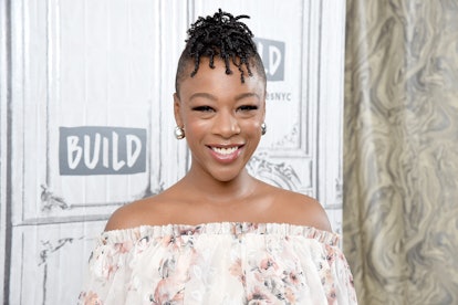 Samira Wiley smiling while wearing a white dress with flowers 