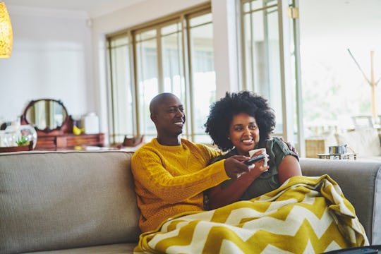 couple watching tv on couch