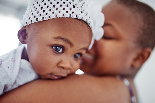 baby girl on her mother's shoulder