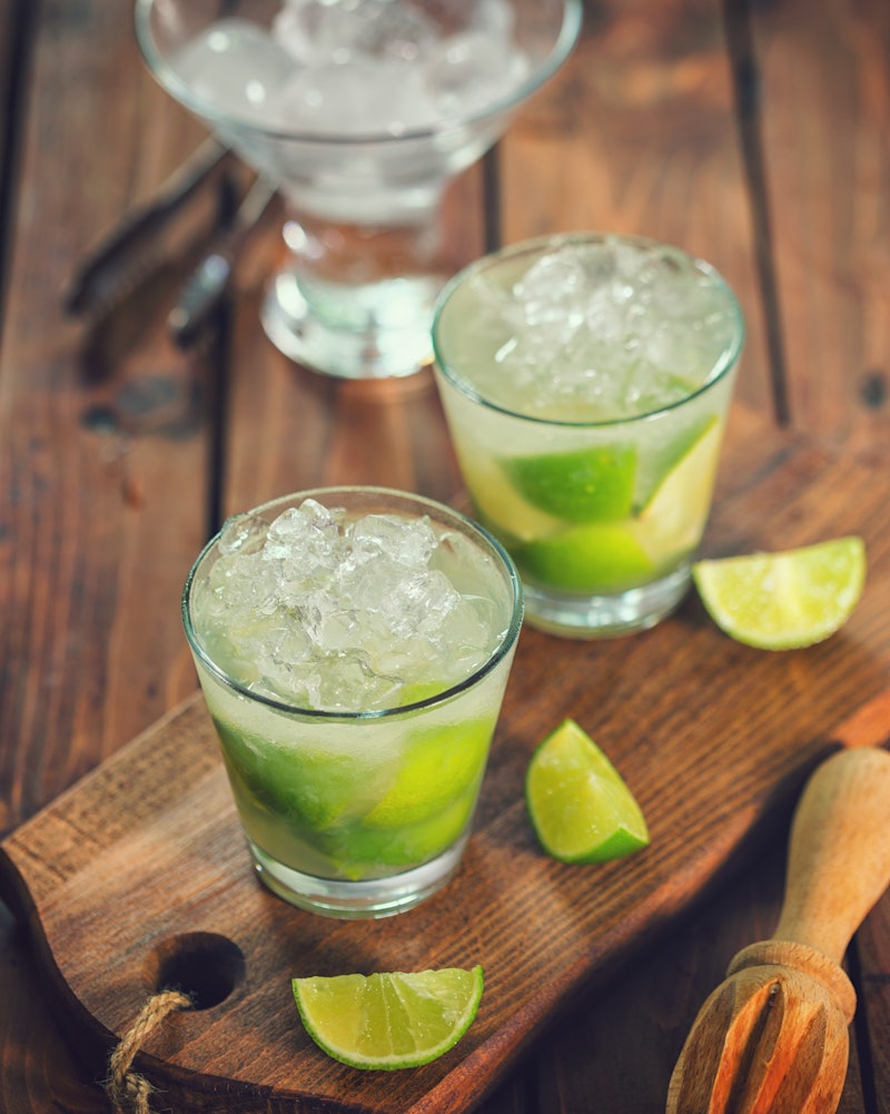 Vodka sodas with lime on a serving board. Doctors explain how white claw vs. vodka soda affect your ...