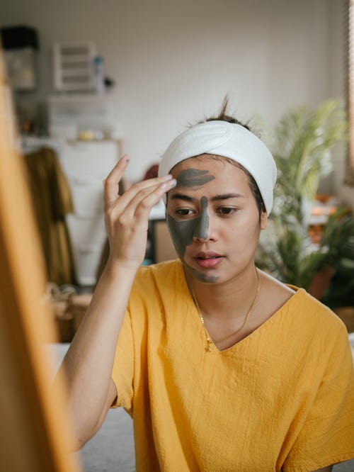 A woman applies a facemask while hungover. How does a hangover affect your body? Doctors have answer...
