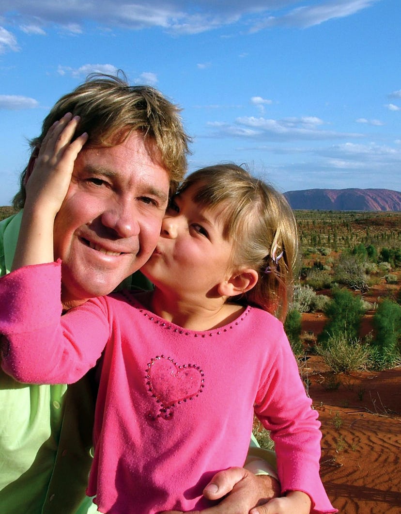 Bindi Irwin kisses her dad's cheek.