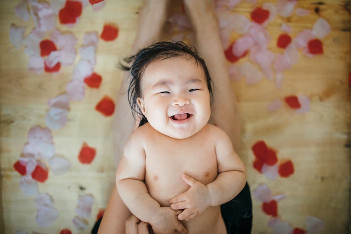 baby after bath on parent's lap