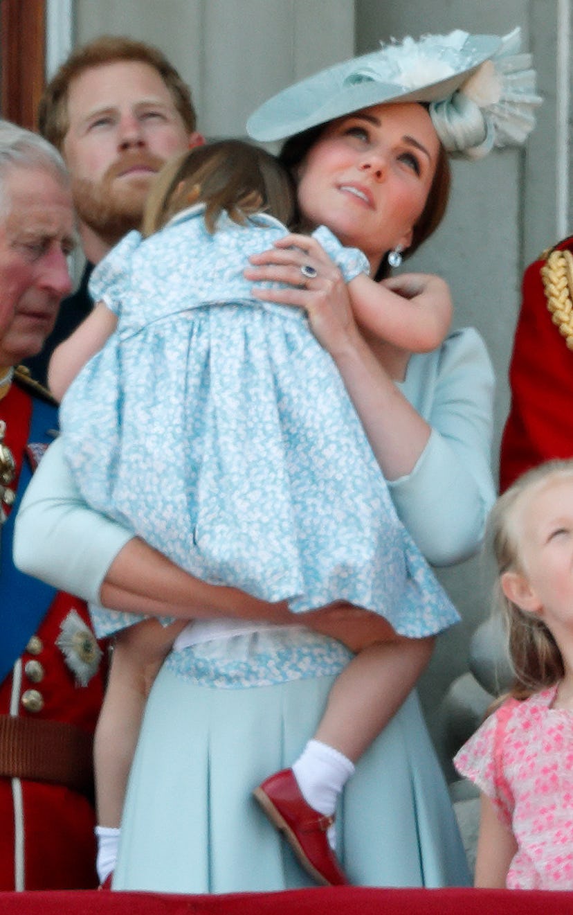 Kate Middleton picks up daughter Princess Charlotte after a fall.