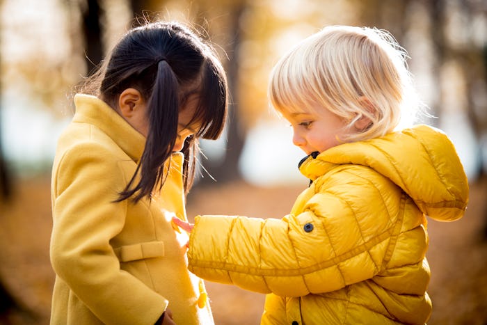 two little girls in yellow fall jackets