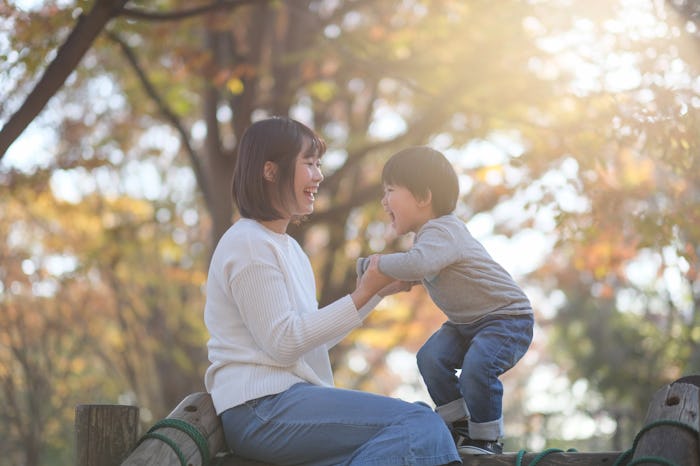 mom and son playing in fall