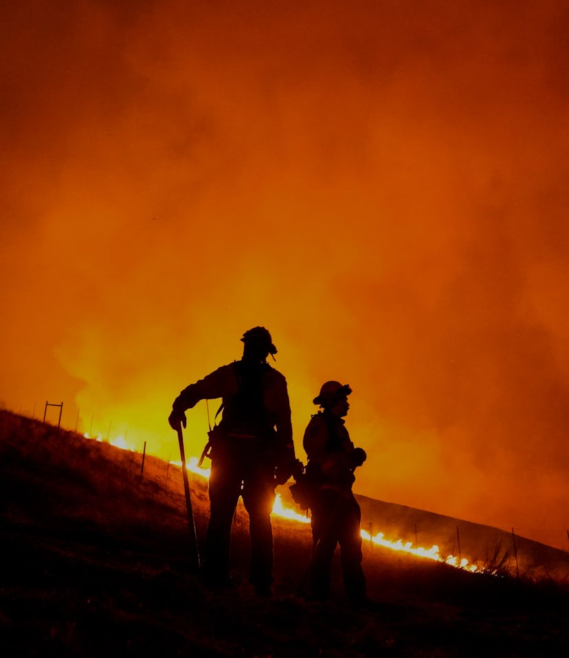 Two firefighters can be seen amid wildfires in California.