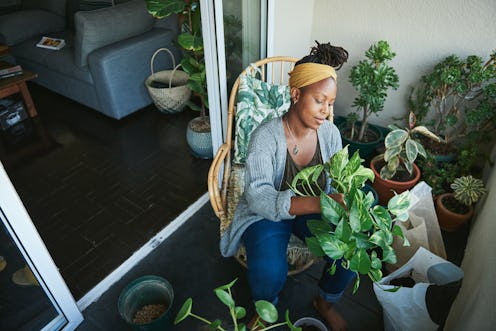 A woman gardens on a balcony. If you're going through intense mood swings, experts say pandemic stre...