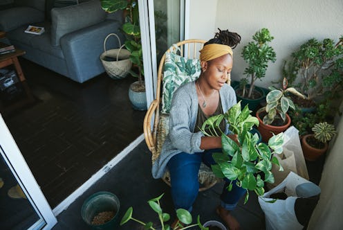 A woman gardens on a balcony. If you're going through intense mood swings, experts say pandemic stre...
