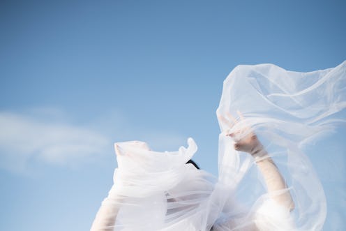 A woman with her hands in a yard of tulle. Here are scientific theories behind how deja vu works.