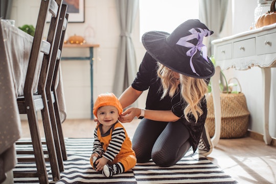 mom getting baby ready to go out for halloween