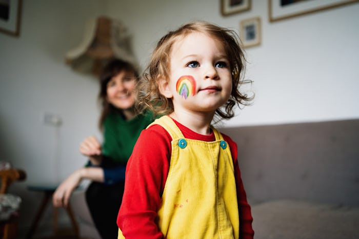 little girl with rainbow on cheek