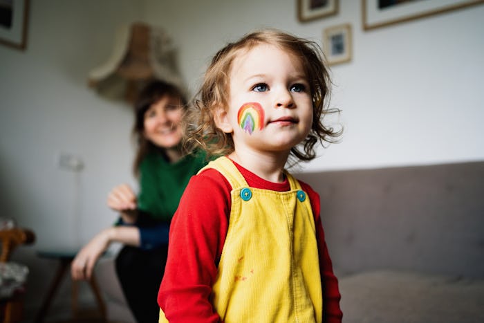 little girl with rainbow on cheek