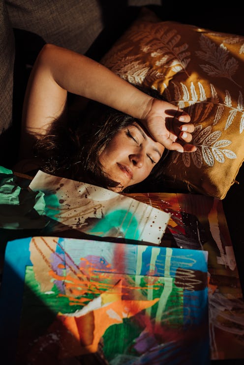 A woman sleeps underneath colorful prints. Sleep experts officially called for an end to daylight sa...