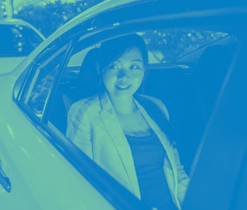 Woman sitting in the back of a car.