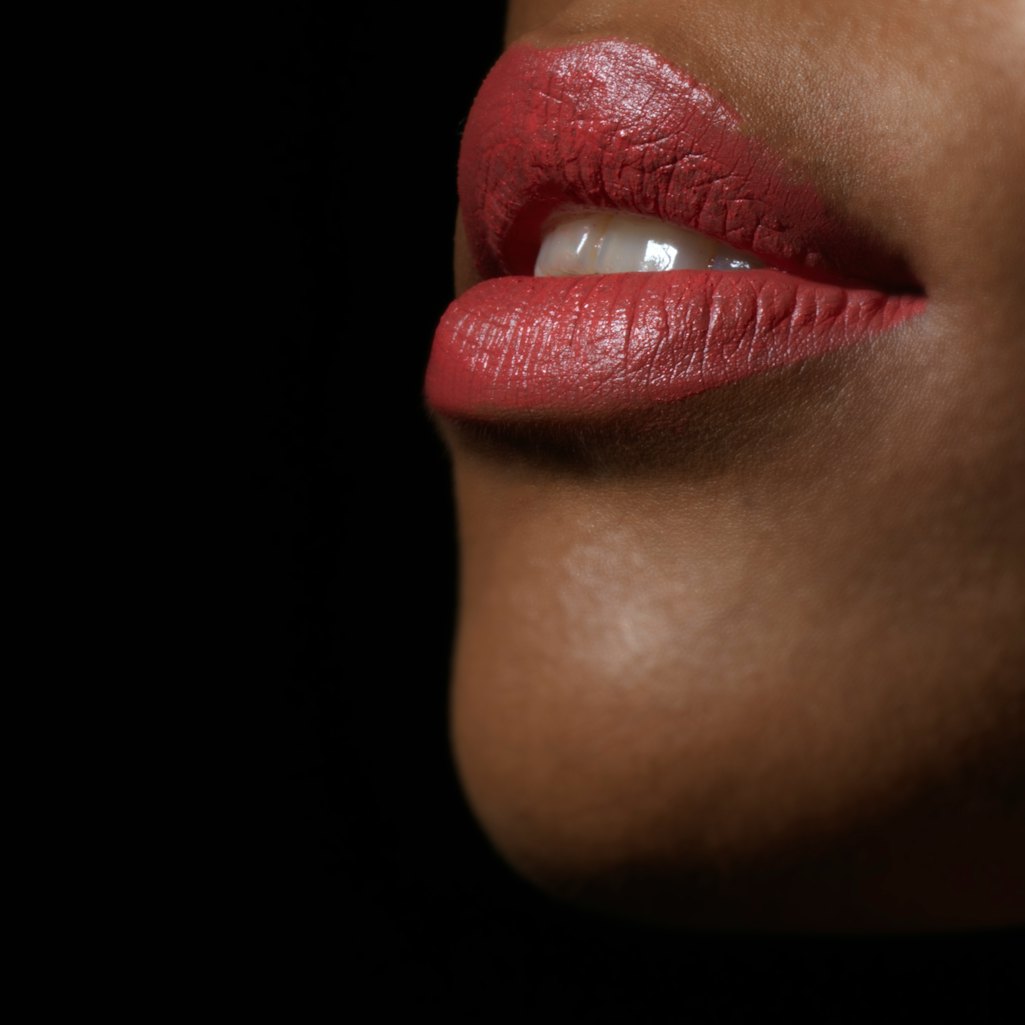 A woman wearing lipstick. Pandemic stress is making people grind their teeth until they crack.