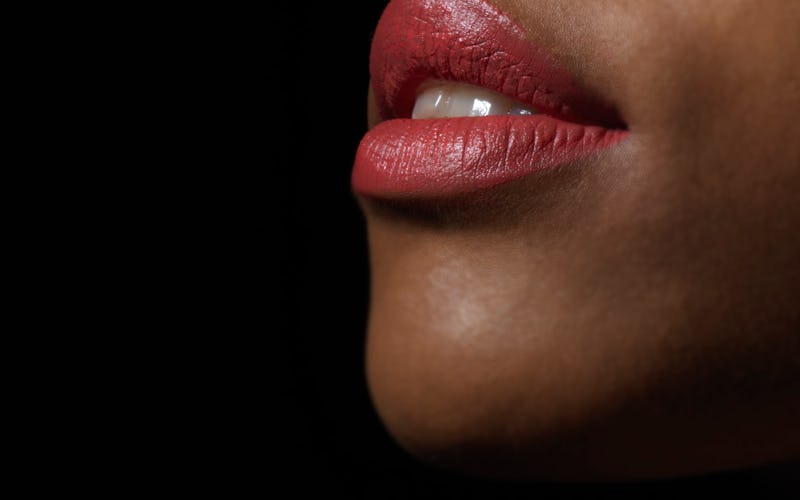 A woman wearing lipstick. Pandemic stress is making people grind their teeth until they crack.