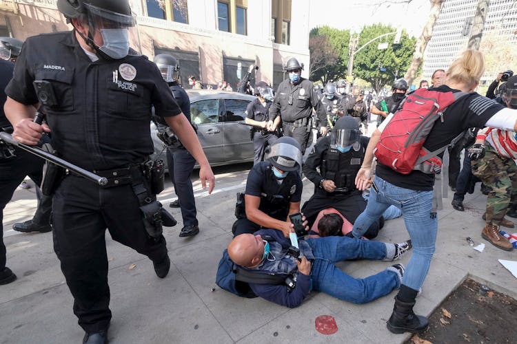 The police beating a man.