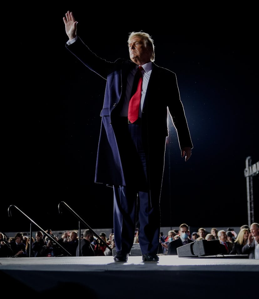 President Trump waving to supports at a campaign rally.