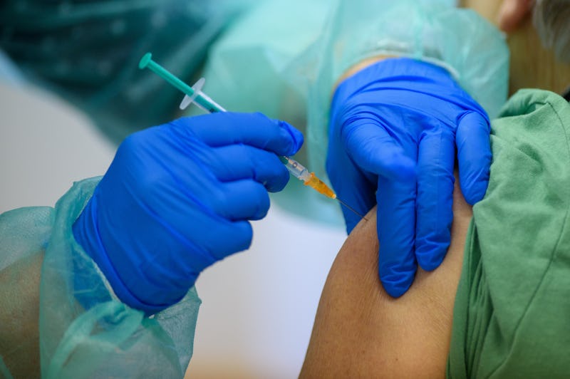 A woman receives a COVID vaccine after recovering from COVID