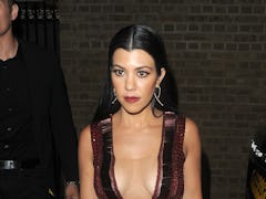 Kourtney Kardashian steps out in a plunging red dress. 