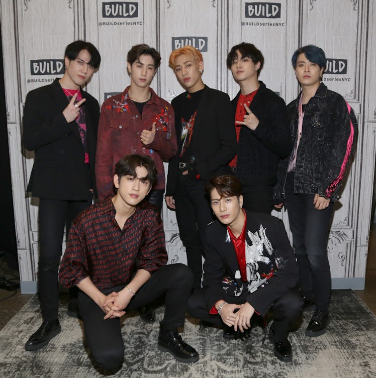 GOT7 pose for a group picture outside the 'BUILD Series.'