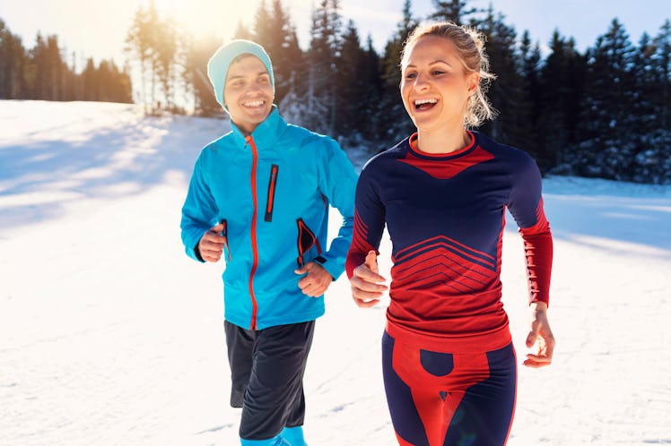 A couple in running gear get out in the snow for a early morning run.