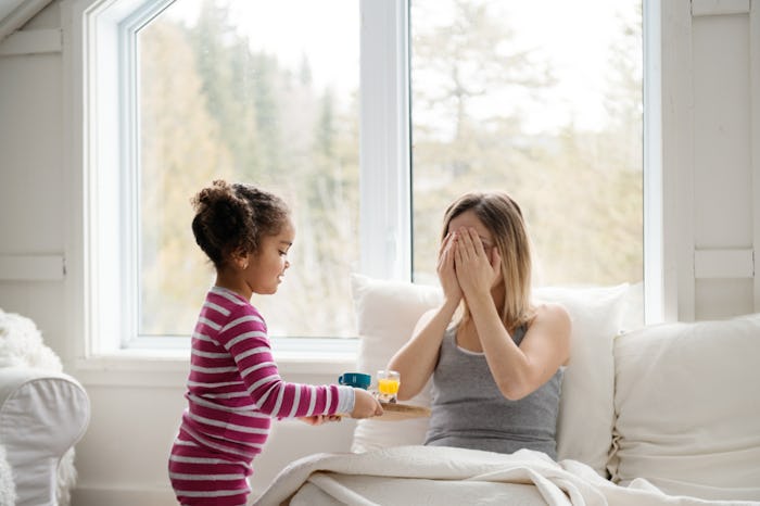 little girl giving mom valentine surprise