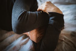 A woman with her hands over her face wants to know if her sadness is actually depression.