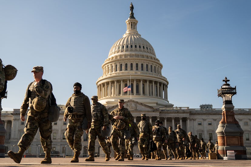 Members of the National Guard march in on the grounds of the US Capitol