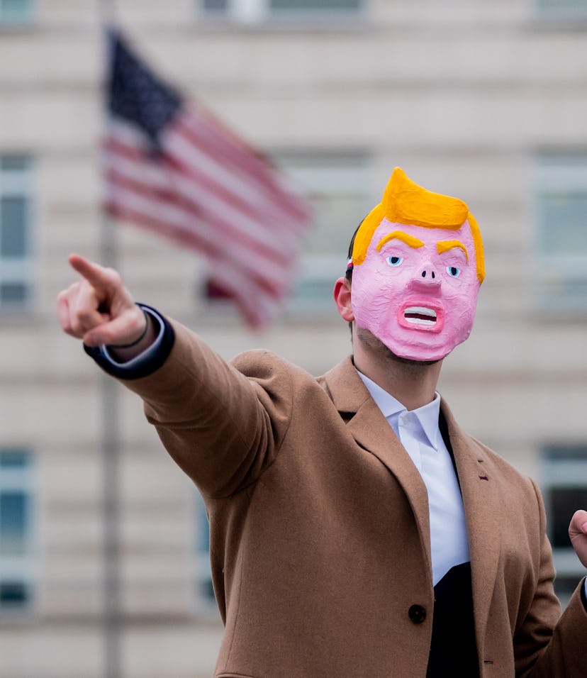 A man in a Trump mask.