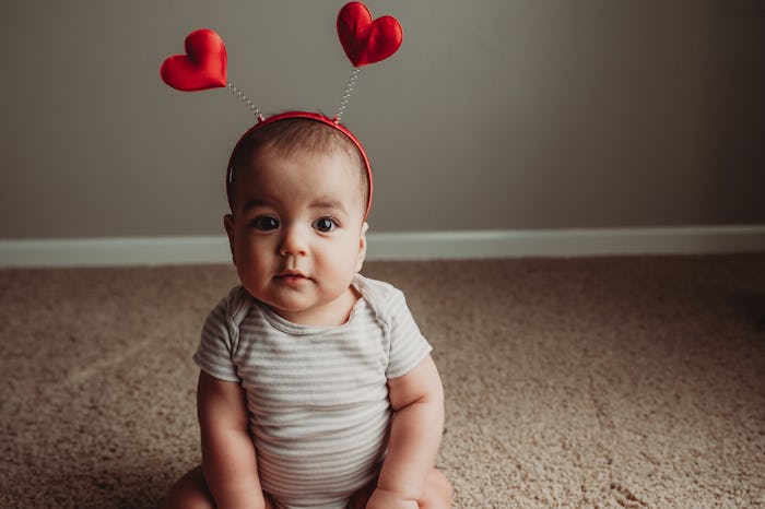 baby sitting up wearing heat antennae